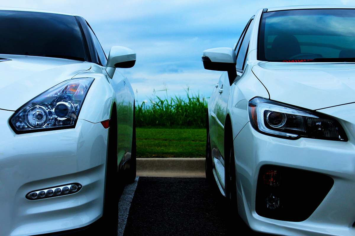 sports car white Nissan GT-R and white Mitsubishi Lancer Evolution 10 automobile